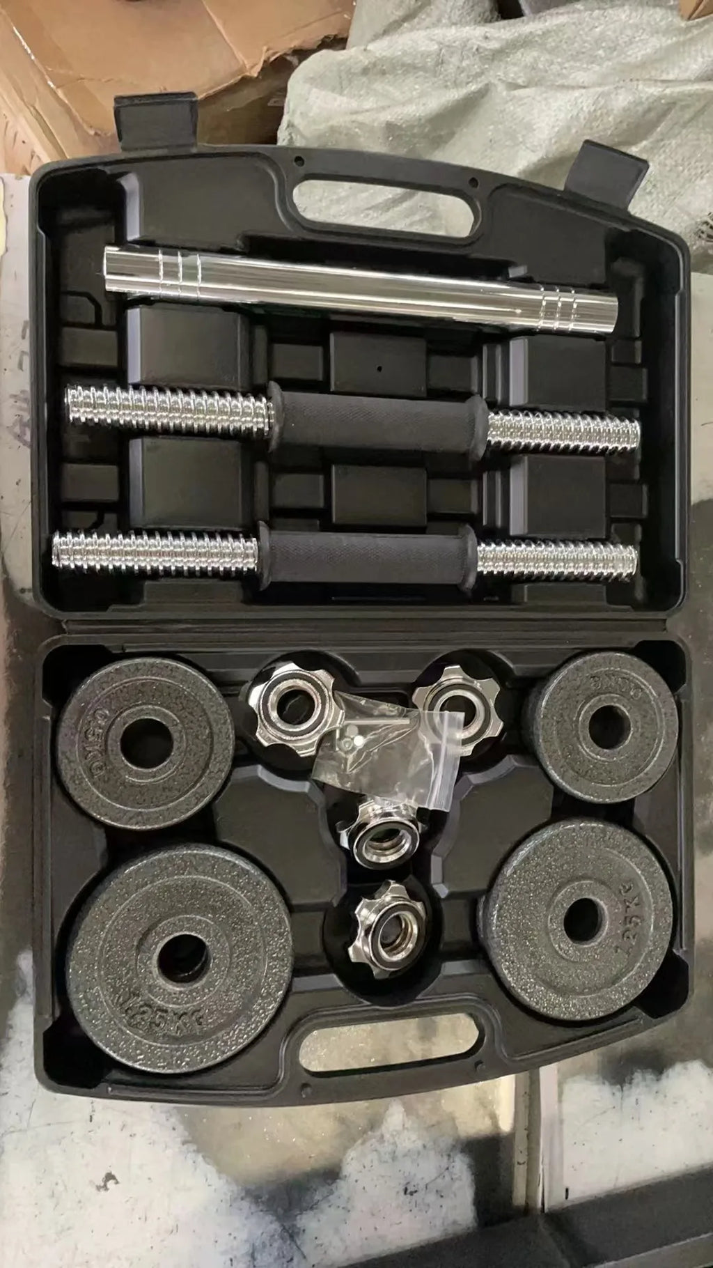 Home gym weightlifting dumbbells of 10kg 15kg 20kg 30kg with set of cast iron dumbbells painted black.